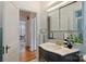Stylish bathroom featuring vintage tiling, modern fixtures, and an open doorway to the home's interior at 2015 Club Rd, Charlotte, NC 28205
