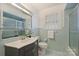 Charming bathroom with vintage tile, updated vanity, and window providing natural light at 2015 Club Rd, Charlotte, NC 28205