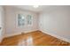 Inviting bedroom showcasing hardwood floors, natural light and closet at 2015 Club Rd, Charlotte, NC 28205