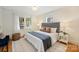 Bright bedroom featuring three sunlit windows, hardwood floors, and stylish decor at 2015 Club Rd, Charlotte, NC 28205