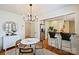 Bright dining room featuring a modern chandelier and bar access to the kitchen at 2015 Club Rd, Charlotte, NC 28205