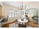 Bright dining room featuring a modern chandelier with hardwood floors, open to living room at 2015 Club Rd, Charlotte, NC 28205