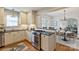 Well-lit kitchen featuring granite counters and stainless appliances with easy flow to dining area at 2015 Club Rd, Charlotte, NC 28205