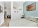 Comfortable bedroom with views into the living room, ceiling fan, and calming blue accent wall at 2125 Southend Dr # 339, Charlotte, NC 28203