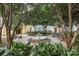 Serene courtyard featuring lush greenery, mature trees, a fountain, and benches for relaxation and community at 2125 Southend Dr # 339, Charlotte, NC 28203
