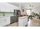 Bright modern kitchen with stainless steel appliances and white cabinetry open to the living room at 2125 Southend Dr # 339, Charlotte, NC 28203