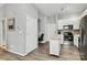 Well-lit kitchen with stainless steel appliances, white cabinets, an island, and an attached office space at 2125 Southend Dr # 339, Charlotte, NC 28203