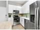 Modern kitchen features stainless steel appliances, sleek white cabinetry, and stylish backsplash at 2125 Southend Dr # 339, Charlotte, NC 28203