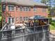 Rear view of a beautiful brick home with an outdoor kitchen and gazebo on a deck at 221 Silvercliff Dr, Mount Holly, NC 28120