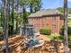 Aerial view of backyard featuring patio with fire pit, a hammock, gazebo and brick home at 221 Silvercliff Dr, Mount Holly, NC 28120