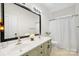 Bathroom with a double sink vanity and a large mirror, and a curtained shower/bath at 221 Silvercliff Dr, Mount Holly, NC 28120