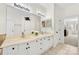 A bathroom featuring double vanity sinks, a large mirror, and a doorway to another room at 221 Silvercliff Dr, Mount Holly, NC 28120