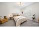 Comfortable bedroom with carpet flooring and a cozy sitting area at 221 Silvercliff Dr, Mount Holly, NC 28120