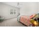 Bedroom with a brightly patterned bed, a small, decorative plant and a large window at 221 Silvercliff Dr, Mount Holly, NC 28120