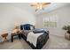 A bedroom featuring a blue bed with wood trim and a window with lots of natural light at 221 Silvercliff Dr, Mount Holly, NC 28120