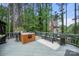 Outdoor deck with a built-in grill station, bar seating, and surrounding greenery at 221 Silvercliff Dr, Mount Holly, NC 28120