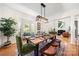 Spacious dining room with a modern chandelier, bay window, and seating for a formal dinner at 221 Silvercliff Dr, Mount Holly, NC 28120
