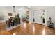 Sunlit dining area with hardwood floors, stylish lighting, and a view to the front yard at 221 Silvercliff Dr, Mount Holly, NC 28120