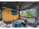 Relaxing gazebo with comfortable seating, a mounted TV, and wooded views at 221 Silvercliff Dr, Mount Holly, NC 28120