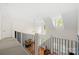 Second floor hallway landing with high ceilings and iron railing at 221 Silvercliff Dr, Mount Holly, NC 28120
