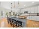 Bright kitchen with a large center island, stainless steel appliances, and a breakfast bar at 221 Silvercliff Dr, Mount Holly, NC 28120