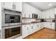 Gourmet kitchen showcasing double ovens, custom cabinetry, and a functional layout at 221 Silvercliff Dr, Mount Holly, NC 28120