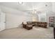 Spacious living room featuring a comfortable leather sectional and neutral decor at 221 Silvercliff Dr, Mount Holly, NC 28120