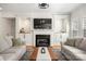 Bright living room with fireplace, built in storage and large television at 221 Silvercliff Dr, Mount Holly, NC 28120