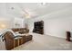 Large living room with a leather sofa, a TV, and a ceiling fan at 221 Silvercliff Dr, Mount Holly, NC 28120