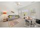 A well-lit office with a gray sofa, and a wooden desk at 221 Silvercliff Dr, Mount Holly, NC 28120