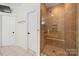 A shower with a glass door, and a built-in bench at 221 Silvercliff Dr, Mount Holly, NC 28120