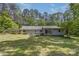 Rear exterior featuring a spacious backyard and deck, perfect for outdoor relaxation at 231 Stockwood Dr, Stanley, NC 28164