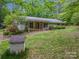 Charming ranch home featuring stone accents, red shutters and a inviting front porch at 231 Stockwood Dr, Stanley, NC 28164
