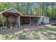 Garage featuring an open carport, a workspace, and ample storage space at 231 Stockwood Dr, Stanley, NC 28164