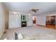 Spacious living room featuring built-in shelving, fireplace, and carpet flooring at 231 Stockwood Dr, Stanley, NC 28164