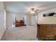 Spacious main bedroom featuring neutral carpet, a ceiling fan, and an ensuite bathroom at 231 Stockwood Dr, Stanley, NC 28164