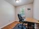 Cozy office space with hardwood floors, natural light, and a comfortable chair at 231 Stockwood Dr, Stanley, NC 28164