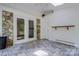 Bright sunroom with stone accents, tiled floor and access to the backyard with glass doors at 231 Stockwood Dr, Stanley, NC 28164