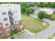 Aerial view of a building with balconies, parking lot, and a grassy area near the street at 2338 Yadkin Ave # 101, Charlotte, NC 28205