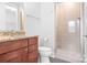 Well-lit bathroom features granite counters, wooden cabinets, and a glass-enclosed shower at 2338 Yadkin Ave # 101, Charlotte, NC 28205