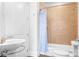 Bright bathroom features a shower-tub combo with a tiled surround and a white sink with modern fixtures at 2338 Yadkin Ave # 101, Charlotte, NC 28205