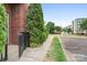 Well-maintained entryway of a brick townhome with a small yard and easy access to nearby parking at 2338 Yadkin Ave # 101, Charlotte, NC 28205