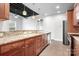 The lovely kitchen includes wood cabinets, granite counters, and stainless steel appliances at 2338 Yadkin Ave # 101, Charlotte, NC 28205