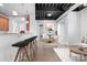 Open living room featuring a kitchen with bar seating and a bright dining area at 2338 Yadkin Ave # 101, Charlotte, NC 28205