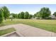 Spacious vacant lot awaiting development, surrounded by mature trees and a concrete patio area at 2338 Yadkin Ave # 101, Charlotte, NC 28205