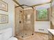 Modern bathroom with a glass-enclosed shower and a window providing natural light, complemented by decorative wallpaper at 2501 Richardson Dr, Charlotte, NC 28211