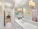 White bathroom with large mirror, vanity with storage, and stylish lighting fixtures, all creating a serene atmosphere at 2501 Richardson Dr, Charlotte, NC 28211