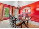 Elegant dining room with red walls, chandelier, and large window for natural light at 2501 Richardson Dr, Charlotte, NC 28211