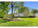 Beautiful two-story home surrounded by mature trees and lush landscaping at 2501 Richardson Dr, Charlotte, NC 28211