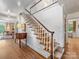 Charming foyer with hardwood floors, staircase, and view to living room at 2501 Richardson Dr, Charlotte, NC 28211